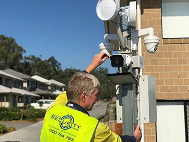 Sunstate Security technician installing a security camera system