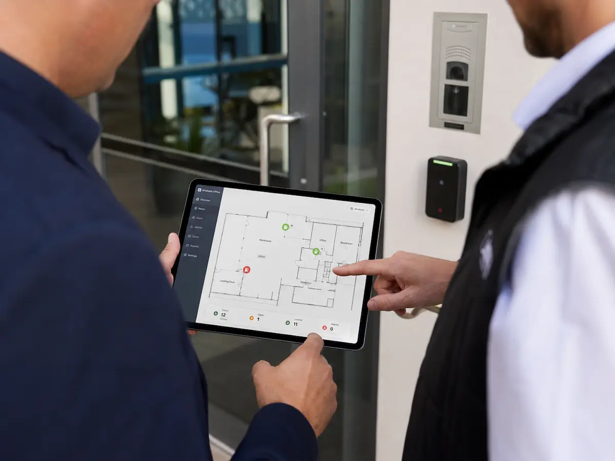 Sunstate Security technician reviewing alarm system requirements with a property manager